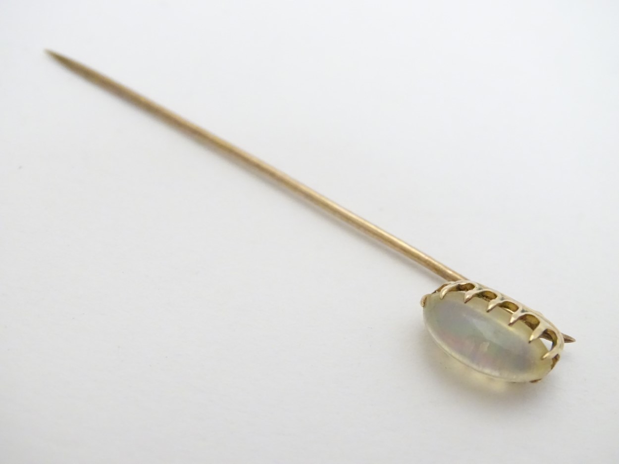 A yellow metal stick pin surmounted by moonstone cabochon 2 1/2" long CONDITION: - Image 3 of 4