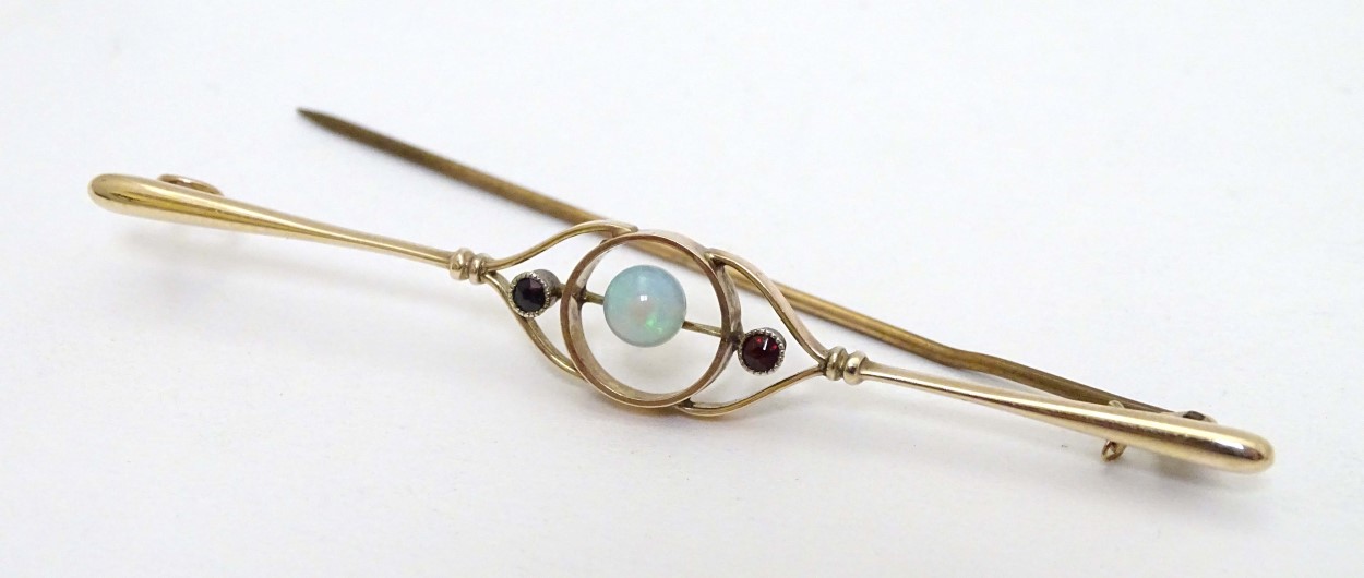 A 9ct gold brooch set with central opal flanked by garnets. - Image 7 of 8