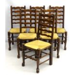 A set of 6 late 19thC oak ladder back dining chairs with envelope rush seats,