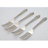 A set of 4 silver cake forks with crossed golf club decoration to handles.