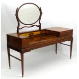 An early 20thC mahogany dressing table with oval mirror above a profusely inlaid carcass depicting