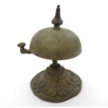 A Victorian brass and lead weighted counter bell with spring action.