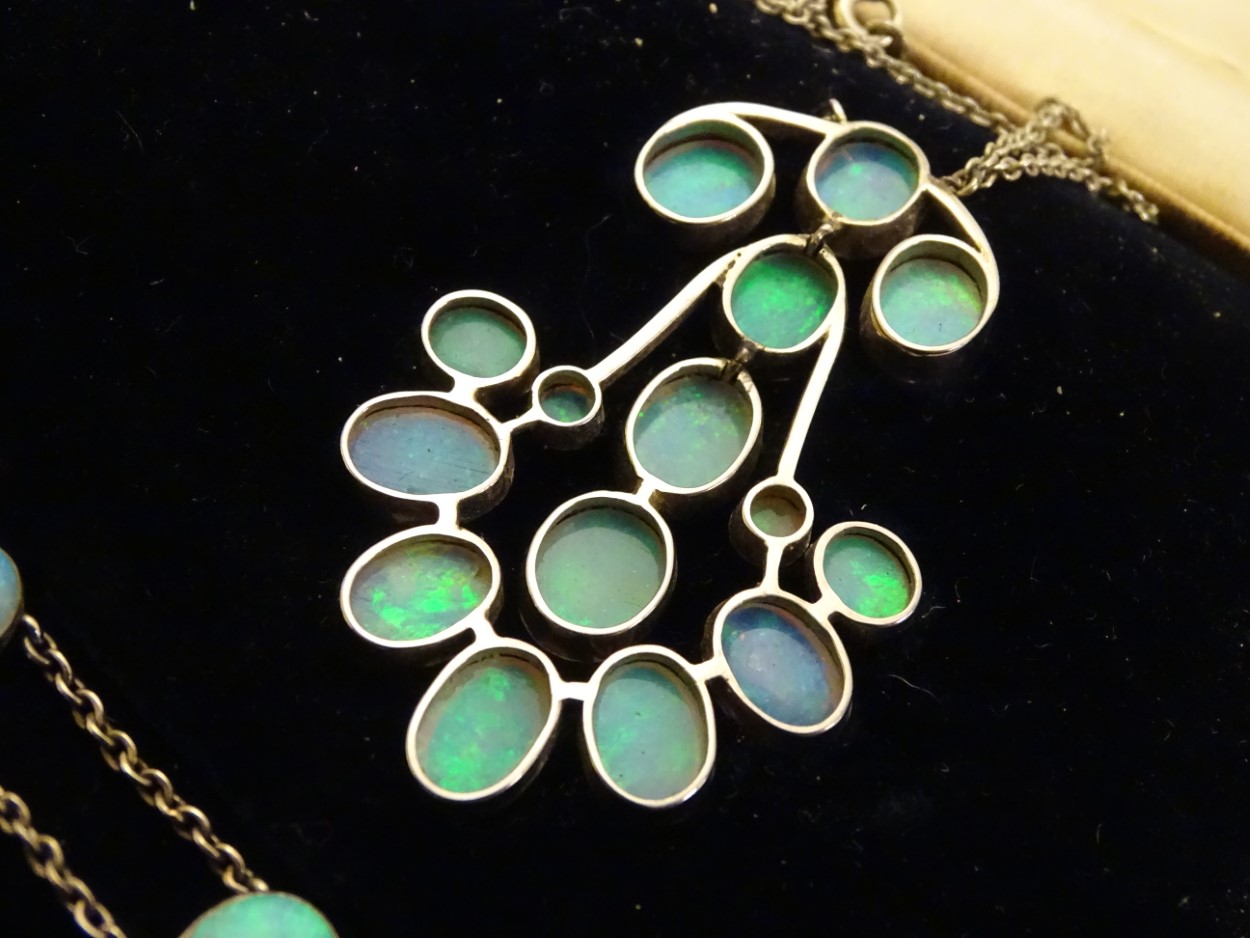 An early 20thC three piece suite of opal jewellery comprising ring, - Image 2 of 6