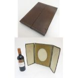 Debenham Gould Bournemouth : A leather cased folding photograph frame with silk and velvet lining