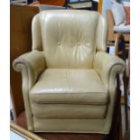 A beige coloured leathered upholstered armchair CONDITION: Please Note - we do not