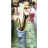 A ceramic stick stand (Chinese) together with 7 assorted sticks, one a gadget stick,