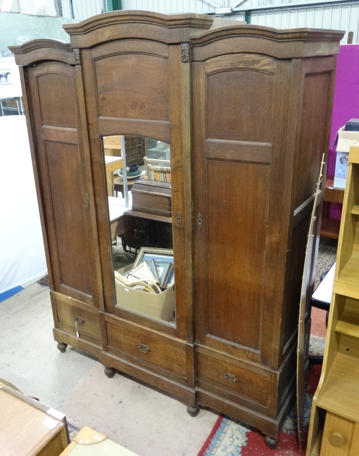 A late 19th / early 20th C oak breakfront triple armoire/ bibliotech with a mirror central door and - Image 2 of 2