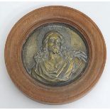 A brass relief of Jesus Christ within an oak frame CONDITION: Please Note - we do