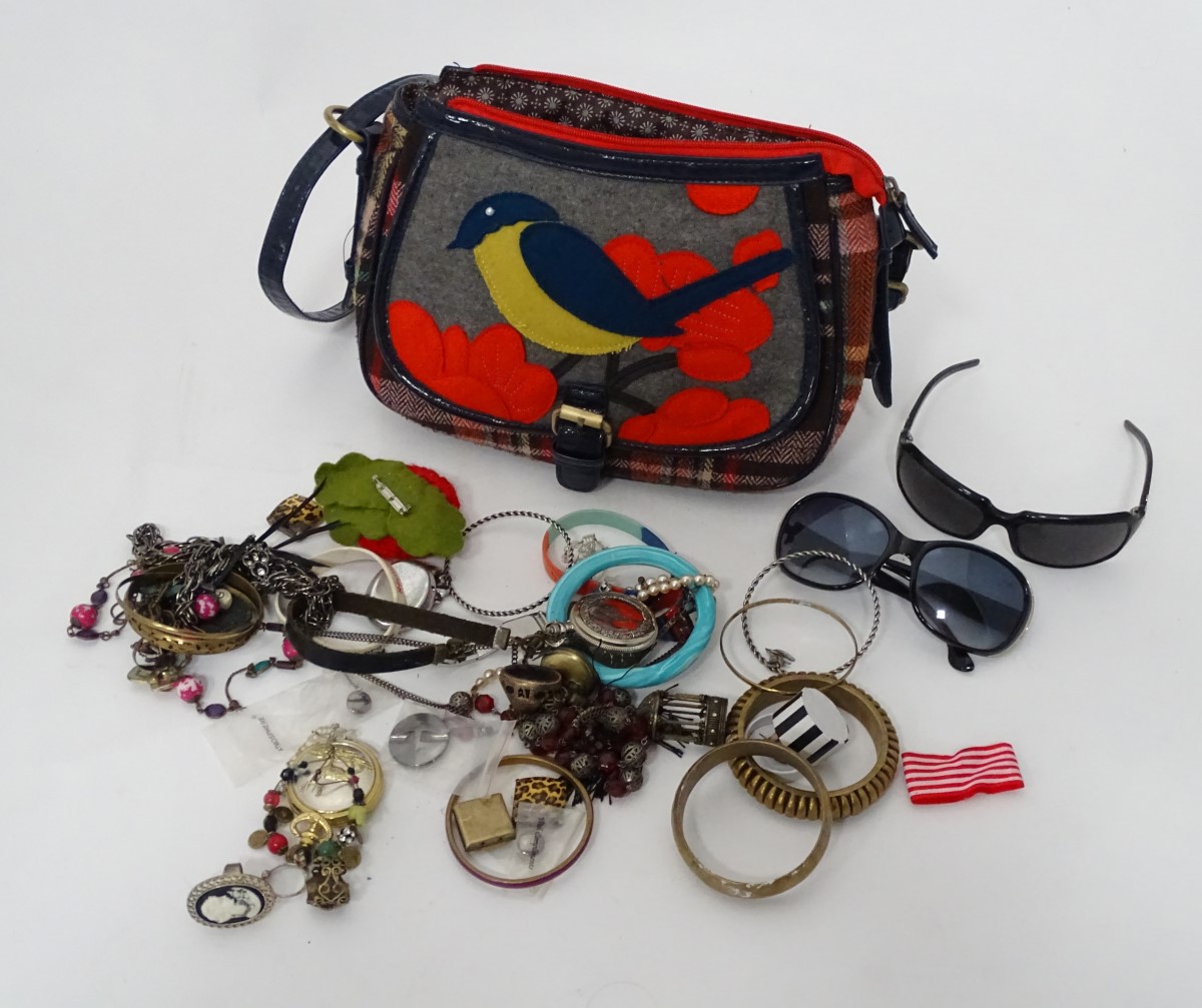 A handbag with bird decoration together with costume jewellery contents CONDITION: