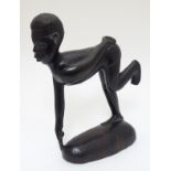 An Ethnographic / tribal carved figure of a runner in start position,