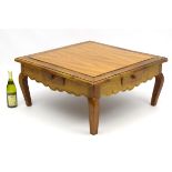 A 20thC cherry coffee table, with four short drawers (one to each side),