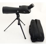 An Optus 20 - 60 x 60 Spotting Scope , having lens caps , sun shade and tripod .