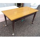 A walnut pad foot kitchen table.