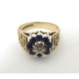 A 9ct gold ring set with diamond and blue stones, hallmarked 1978 maker L.