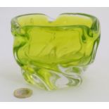 A studio glass bowl of lime green glass,