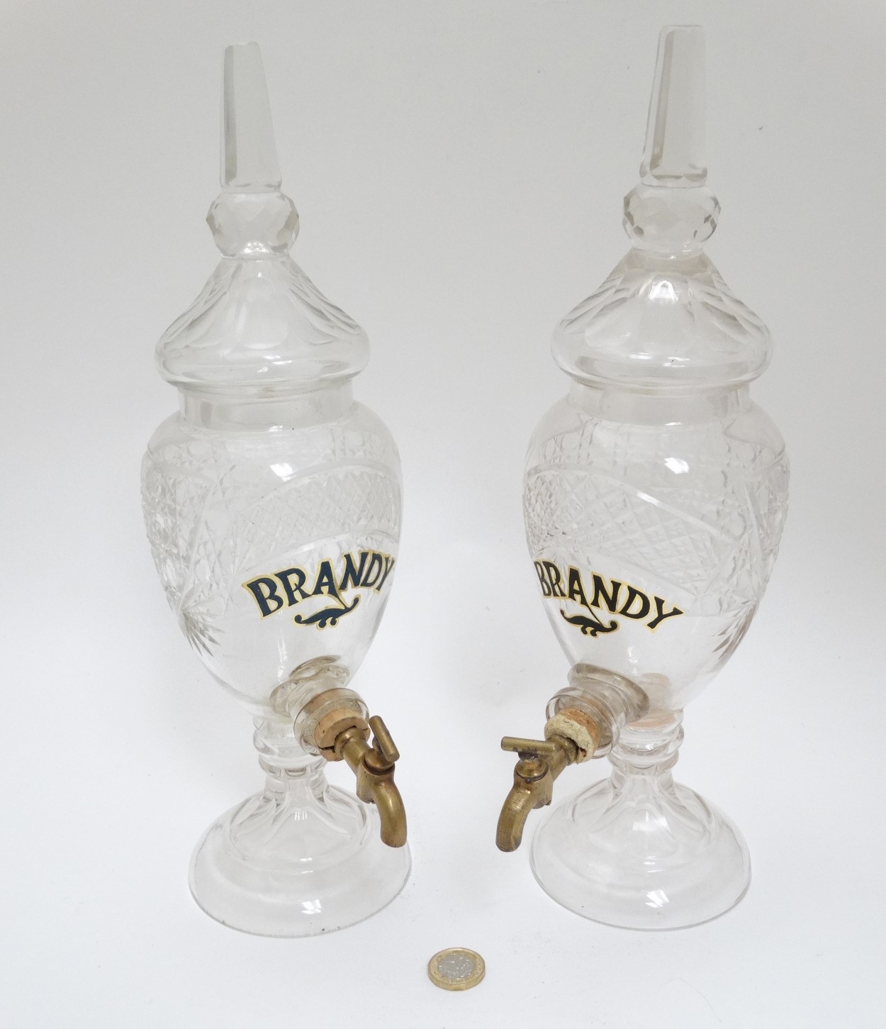 A matched pair of bar top cut glass Brandy dispensers.