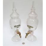 A matched pair of bar top cut glass Brandy dispensers.