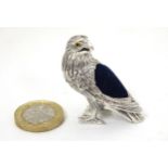 A white metal novelty pin cushion formed as an Eagle.
