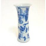 A Chinese blue and white Gu vase with underglaze blue decoration depicting imperials in a pagoda