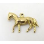 A 9ct gold charm / pendant formed as a horse.