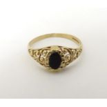 A 9ct gold ring set with dark coloured stone CONDITION: Please Note - we do not