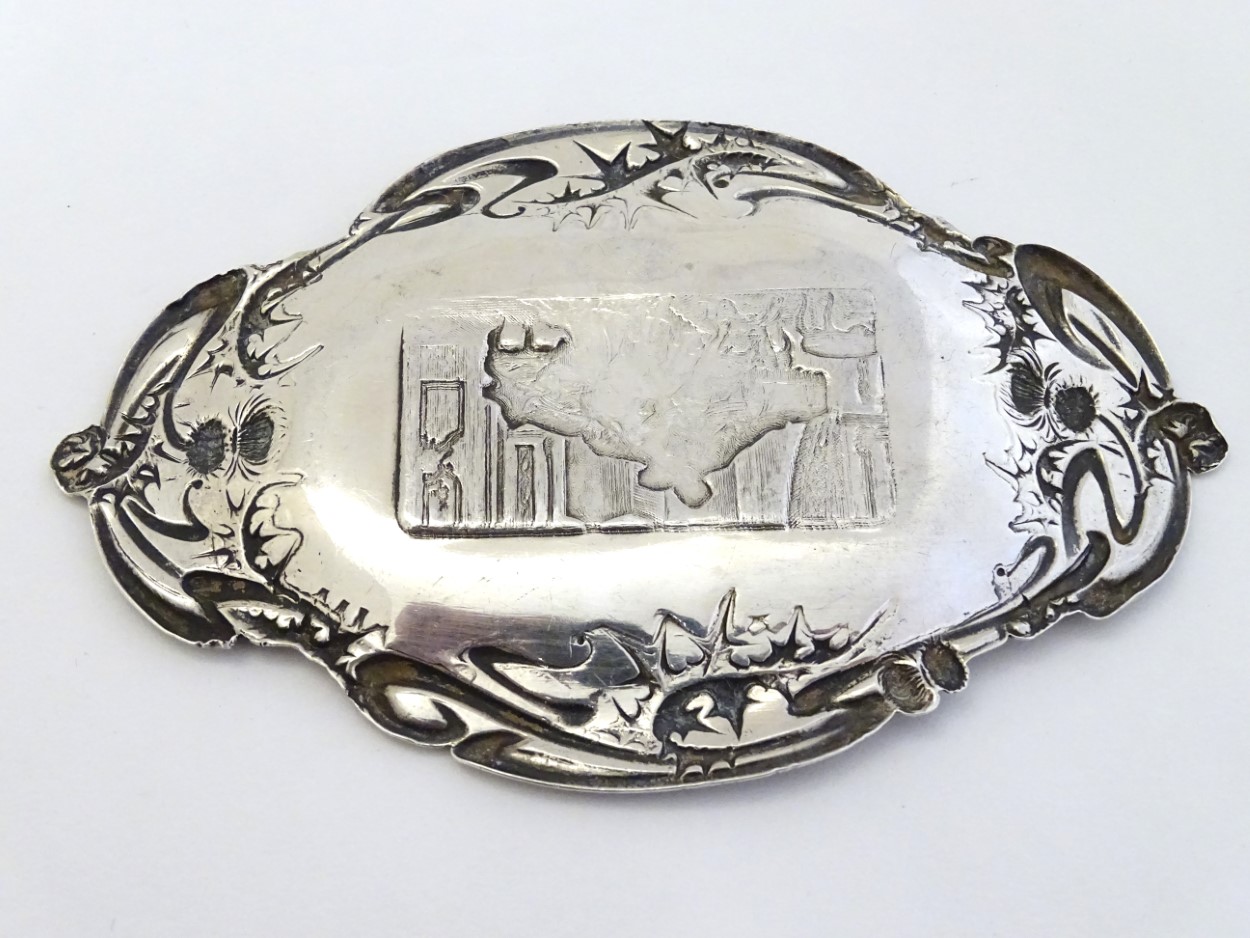 A silver pin dish with thistle decoration to border and interior scene to centre. - Image 2 of 5