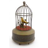 Automaton : a 20thC novelty clockwork brass birdcage with singing bird having integral winder