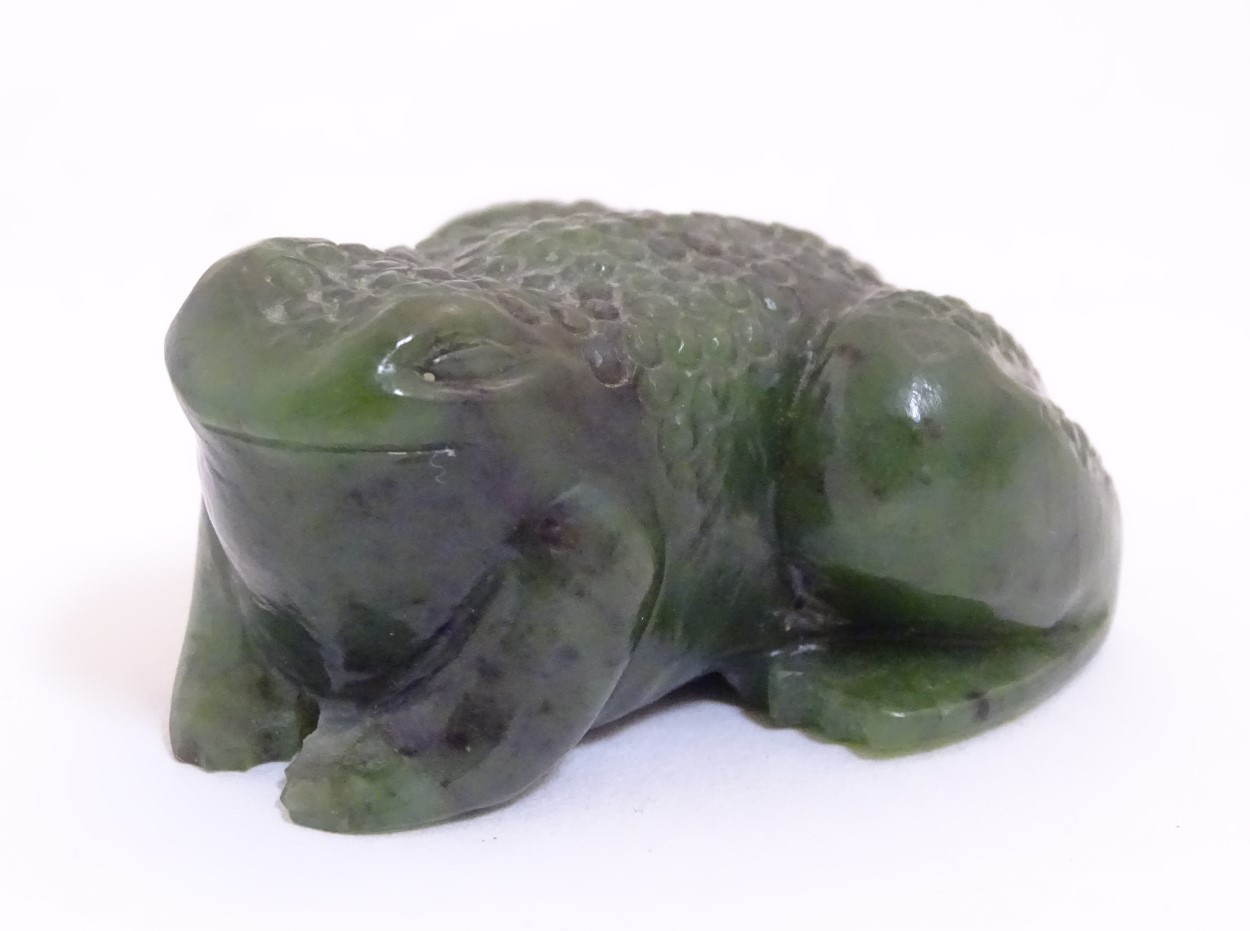 Lee-Roy Mullings of New Zealand: A carved dark green jade model of a toad/frog. Signed under.