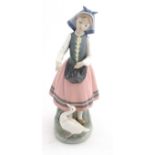 A Lladro figure of a girl feeding a duck, 'Josefa Feeding Duck', no. 5201, approx. 10" high.