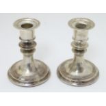 A pair of silver candlesticks hallmarked London 1910 maker Mappin & Webb.