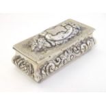 A silver dressing table box with hinge lid and embossed decoration.