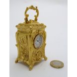 A 21stC gilded Rococo style miniature carriage clock ( timepiece ) , 3 3/4" high.