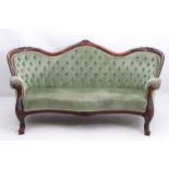 A late 19thC mahogany settee with camel back and carved top rail,