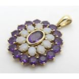 A 9ct gold pendant with central amethyst bordered by opals and further amethyst 1 1/4" long