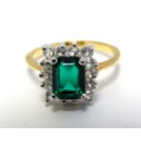 A gilt metal dress ring set with green and white stones CONDITION: Please Note -