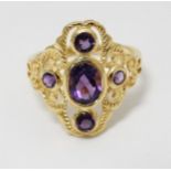 A silver gilt ring set with amethysts.