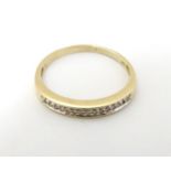 A 9ct gold and diamond half eternity ring set with approx 15 diamonds in a linear setting.