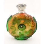 An Oriental glass vinaigrette bottle with white metal top.