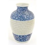 A blue and white Chinese baluster vase decorated with a floral pattern and a reticulated banded