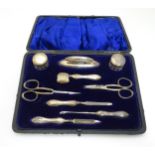 Cased manicure items comprising files, scissors, nail buffer etc with silver handles etc.