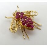 A 14ct gold brooch formed as a bee set with rubies.