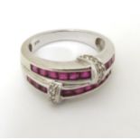 A 9ct white gold ring set with bands of red stones and diamonds.