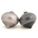 Christmas decorations : two glass baubles one grey the other black.
