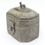 A white metal small table casket / spice box with foliate decoration and handle formed as a dog.
