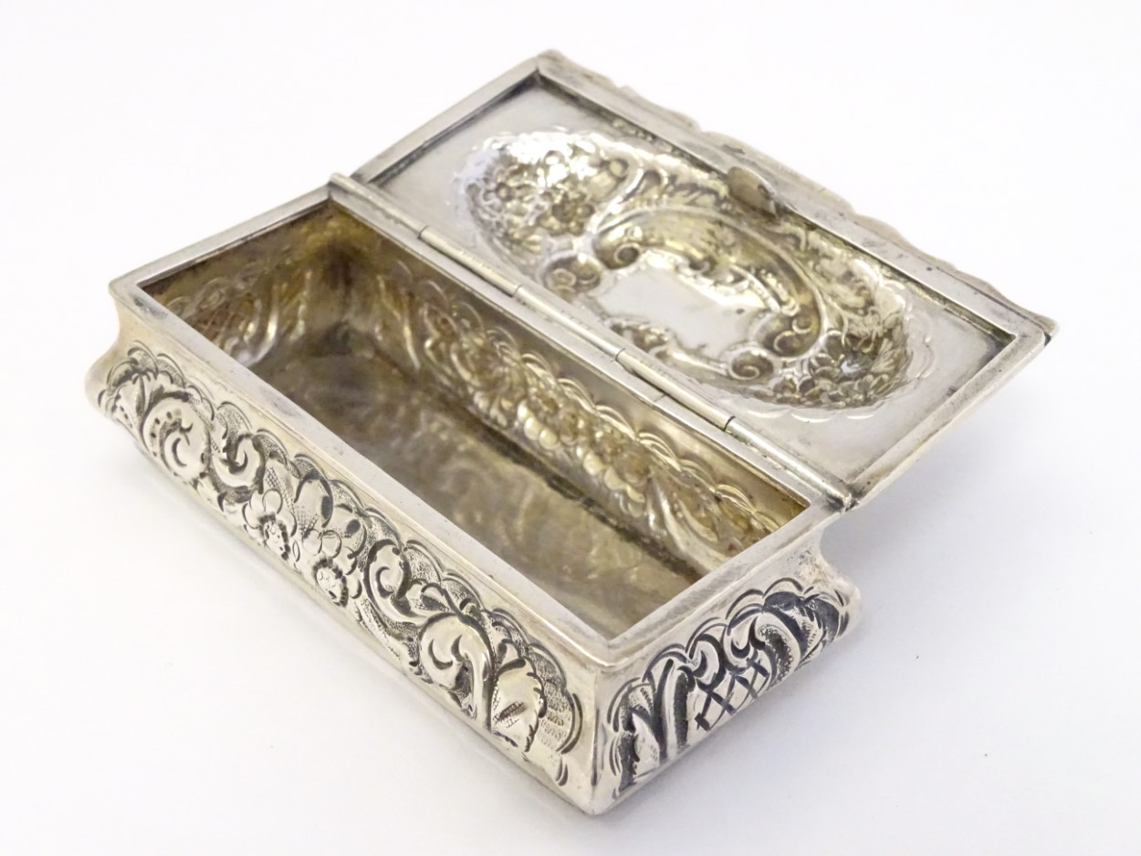 A silver dressing table box with hinge lid and embossed decoration. - Image 4 of 6