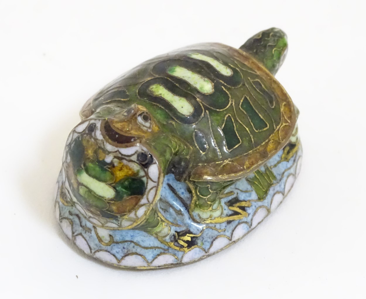 An Oriental cloisonne image of 2 turtles.