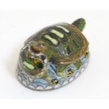 An Oriental cloisonne image of 2 turtles.