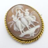 A late 19thC / early 20thC cameo brooch depicting 3 graces within a gilt metal mount.