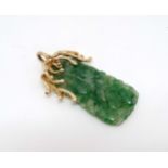 A jade pendant with 14ct gold mount.