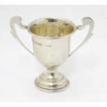 A small silver pedestal twin handled trophy cup hallmarked Birmingham 1927 maker J W Tiptaft & sons